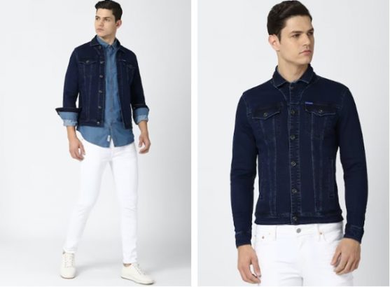 Man in a denim jacket, light blue shirt, white pants, and sneakers.