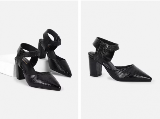 A pair of black textured heels with pointed toes and ankle straps against a white background.