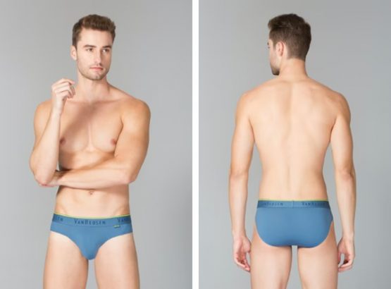 Two images of a man in blue underwear, one showing the front and the other the back, against a grey background.