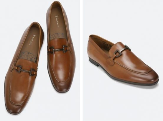 A pair of polished brown leather loafers with metal buckle detail, displayed from top and side views.