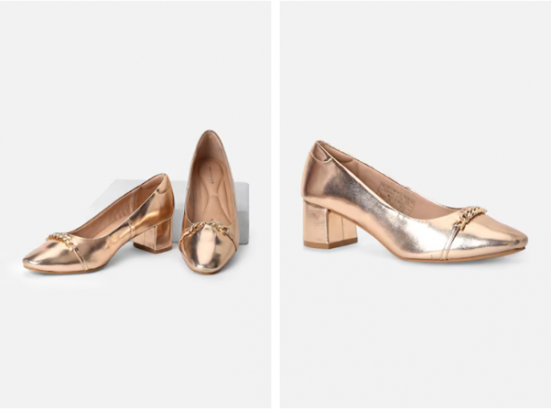 A pair of metallic gold women's loafers with low heels and chain detail on a white background.