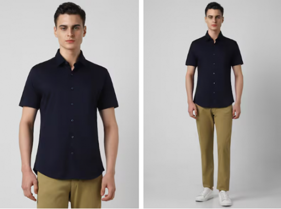 Man in a navy shirt and olive trousers with white sneakers on a plain background.