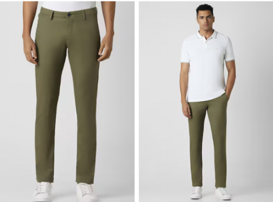 Model wearing olive green trousers with a white polo shirt and white sneakers.
