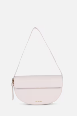 A pale pink shoulder bag with a white strap on a white background.