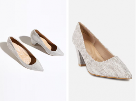 A pair of textured, silver pointed-toe high heels on a white background.