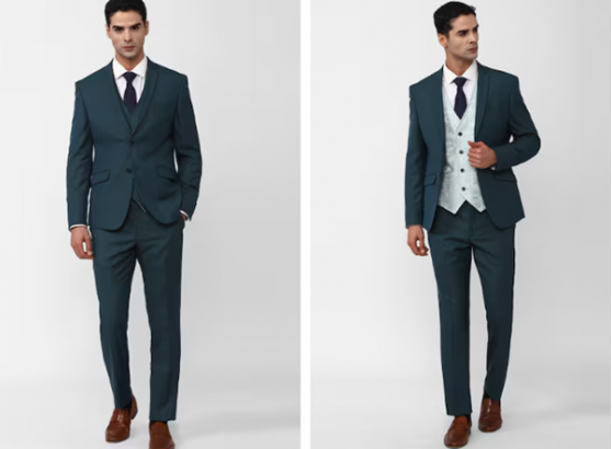Two mannequins in matching teal suits, one with a tie and the other with a vest.