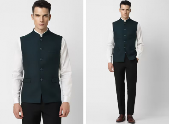 A mannequin dressed in a green vest, white shirt, black trousers, and brown shoes.