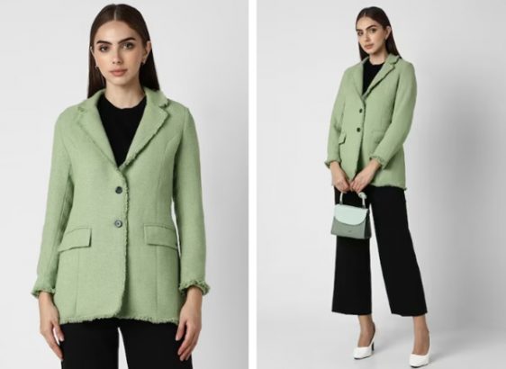 a woman in a green jacket and black pants