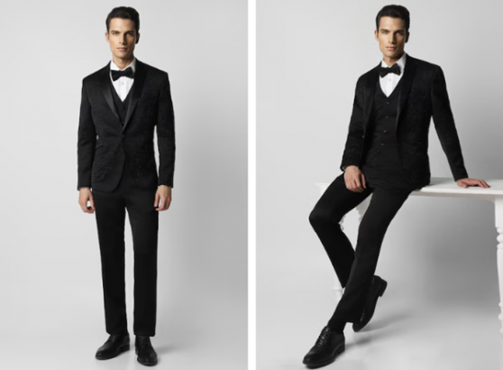 Man in black tuxedo standing and sitting with one foot on a bench.