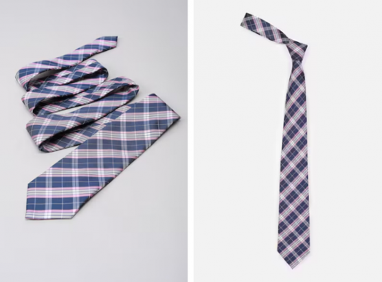a blue and white tie laying on top of a white table