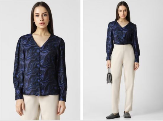 a woman in a blue printed top and white pants