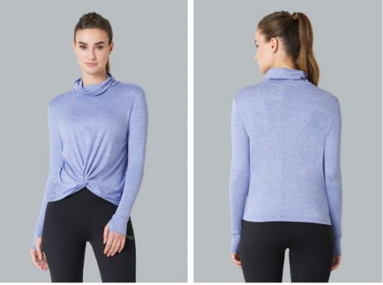 a woman wearing a blue sweater and black pants
