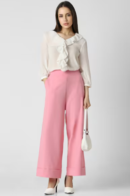 a woman wearing pink pants and a white blouse