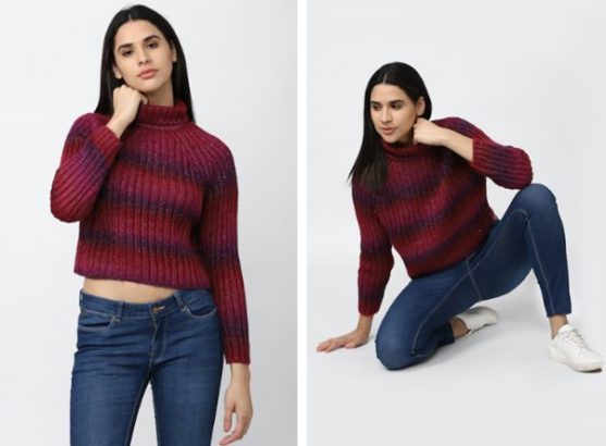 Two poses of a person modeling a red and purple sweater with jeans.