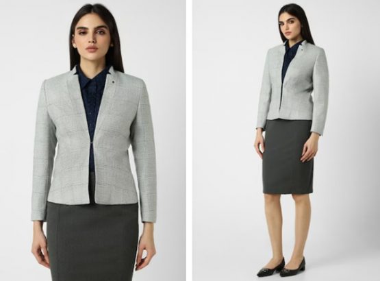 a woman in a skirt and blazer standing next to each other
